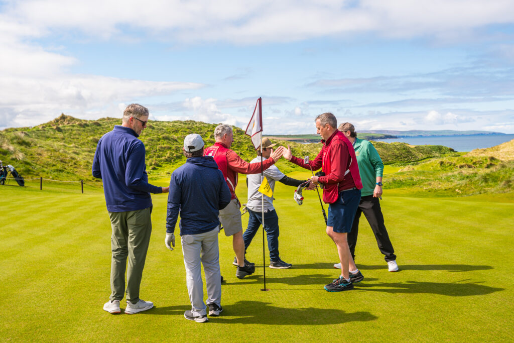 Golfers celebrating together on an Irish links course