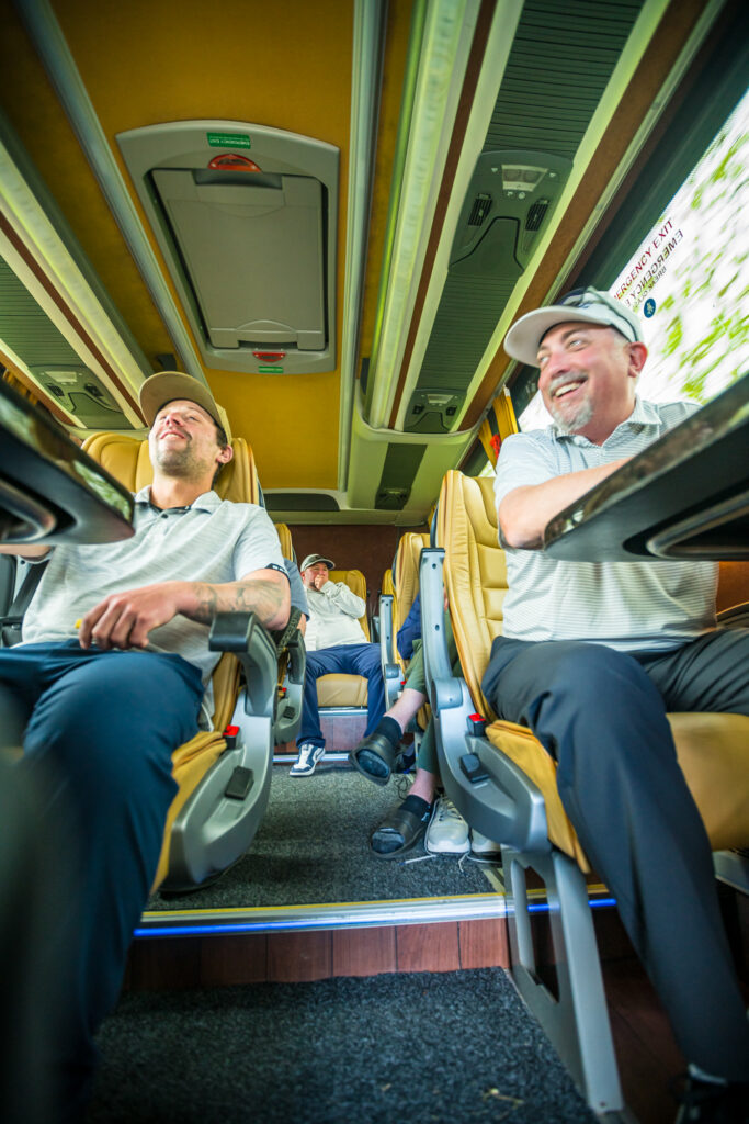 Golf travelers relaxing together on group transportation in Ireland