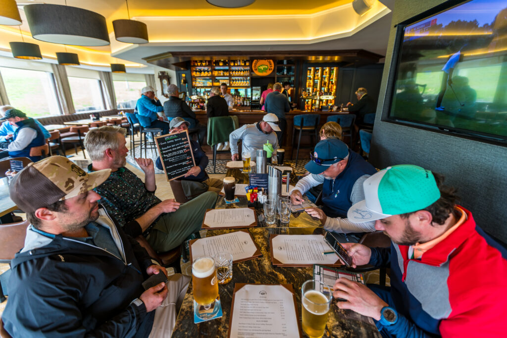 Golf travelers sharing a meal after a day of golf in Ireland