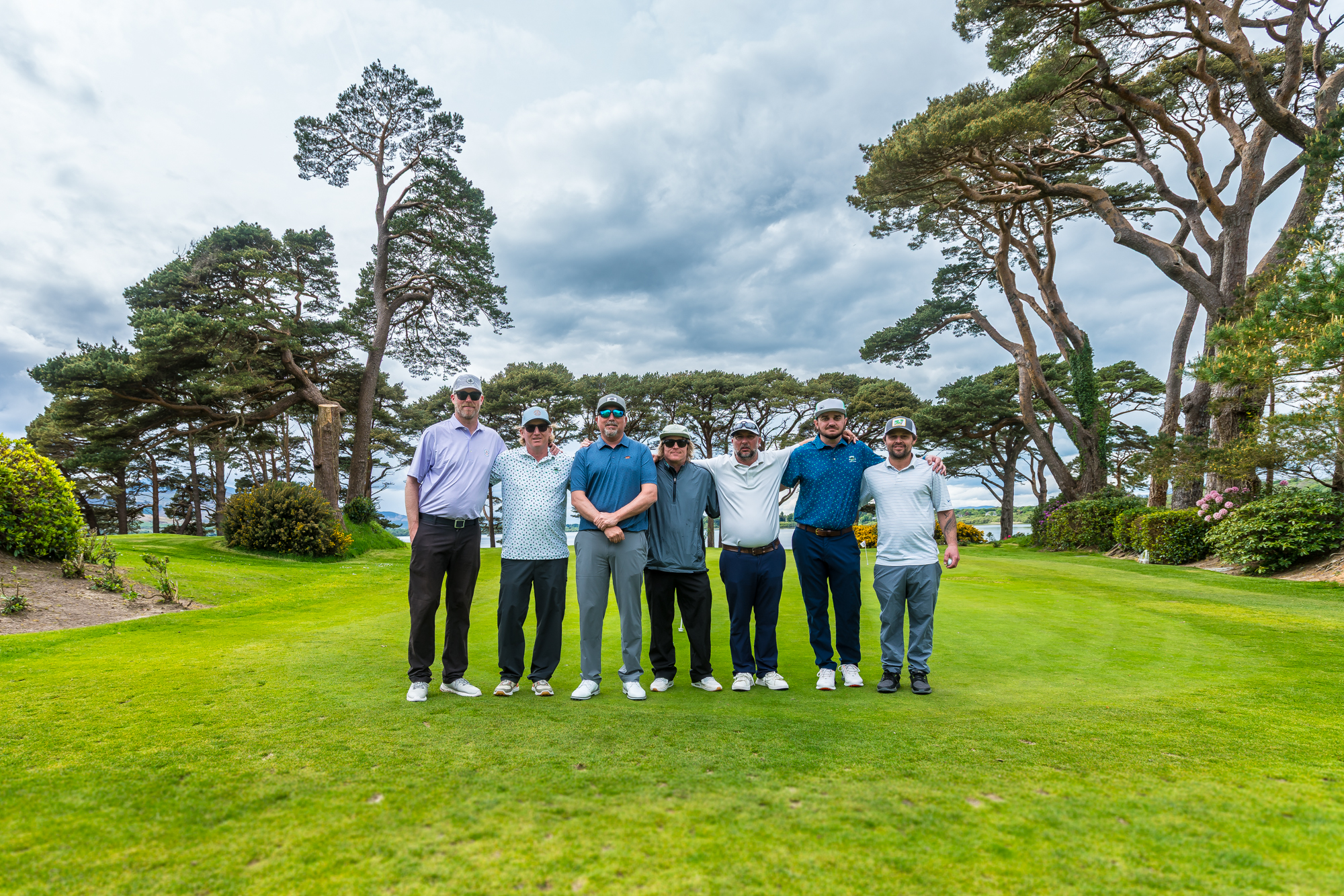 Seven golfers standing together on a course in Killarney, Ireland