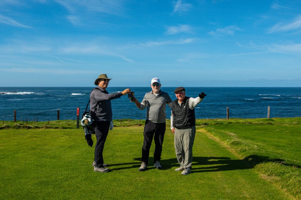 Three Golf Nomad travelers together beside the Atlantic during the Kilkee extension