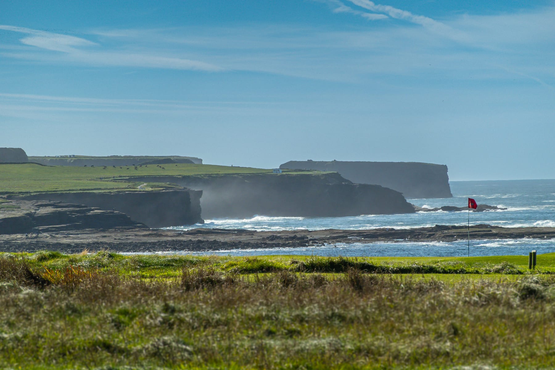 Atlantic waves breaking against the cliffs beside the course at Kilkee